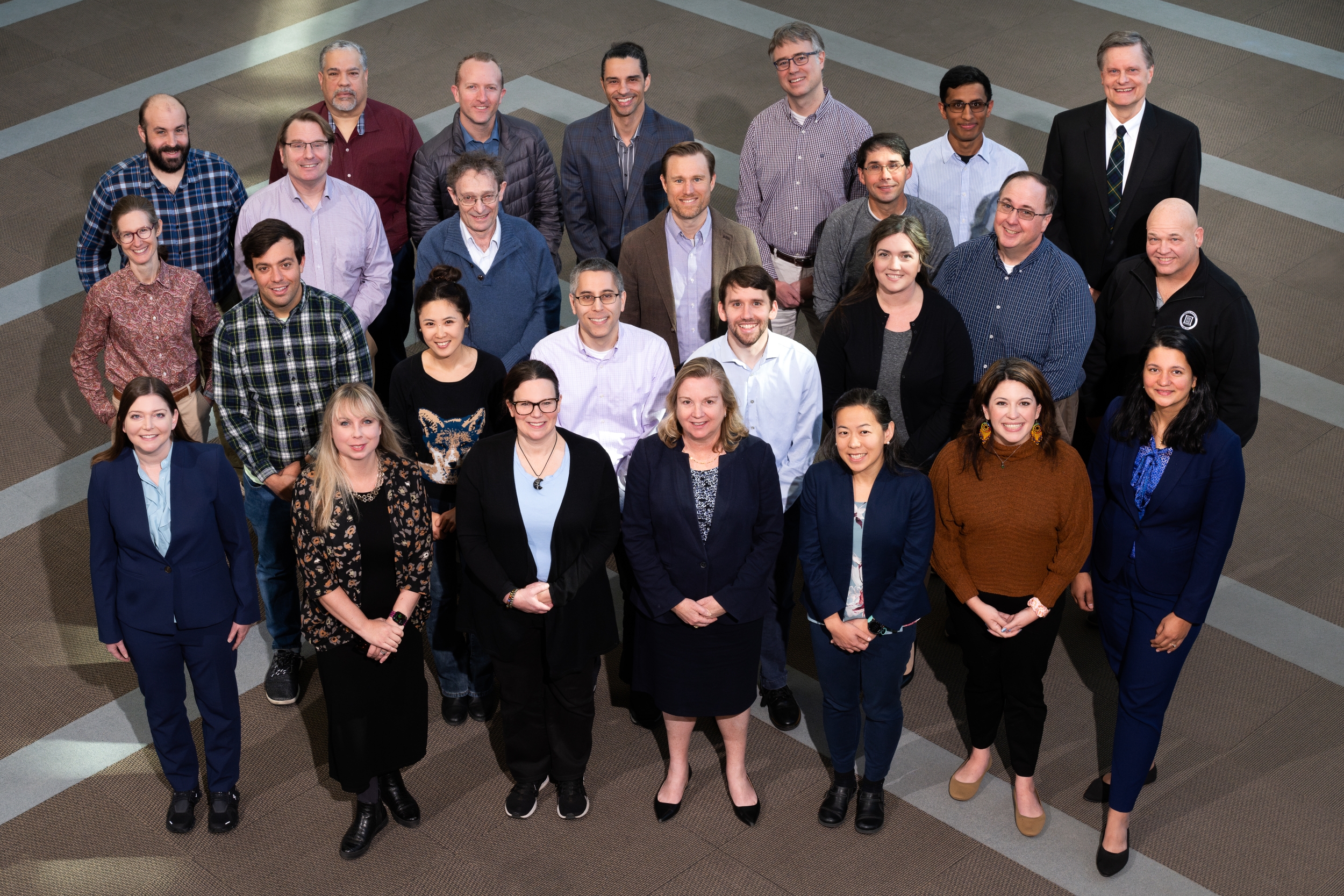 A group photo in the Laboratory's lobby showing RAAINS committee members.